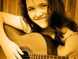 A girl learning the guitar