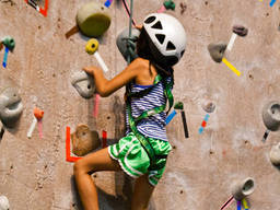 Kids engaging in indoor rock climbing should wear proper gear.