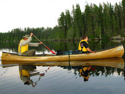 Mother and sons on paddle boards.