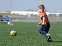 A kid getting fit at soccer camp.