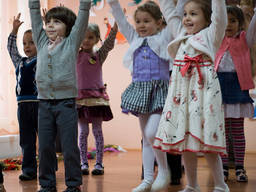 Preschoolers having their class outdoors.