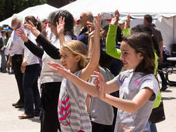 Kids and adults practising tai chi