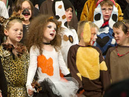 Kids in costume performing a play at their local theatre school