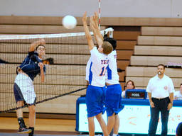 Boys playing volleyball on their school holiday