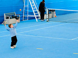 A kid playing tennis at Melbourne Park