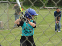 A child concentrates as he prepares to bat