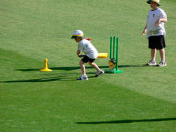 A young boy prepares to bat the ball in his local cricket ground