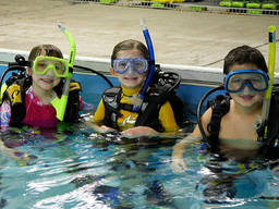 Young scuba diving enthusiasts in the pool