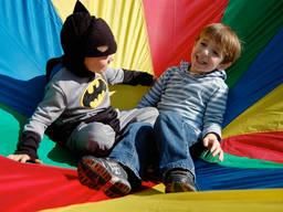 Two kids enjoying themselves in a superhero party