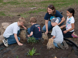 Children studying plants with an instructor