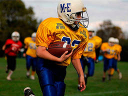 Young athletes on the field playing American football!