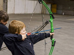 A kid learning how to hit a target