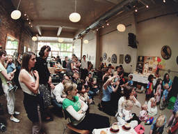 Groups of families gathered at a cafe for a show