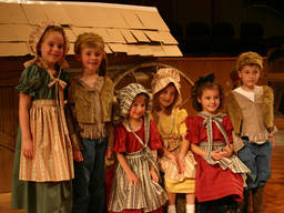 Kids enjoying being part of a stage production they have been cast in together