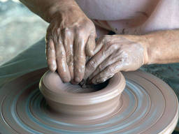 A person working on a pottery wheel