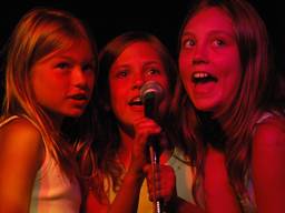Girls having fun singing the karaoke.