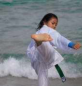 A green belt student executing a back kick at beach training in Coogee. (Feb 2016)