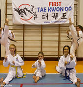 Some female members (from a young white belt beginner to an adult lady instructor) demonstrating the importance of flexibility with the splits to high kicks.