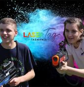 two kids playing laser tag with banner