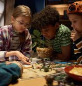 Spectrum Quest kids lean in on an intense dice roll!