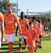 Junior walking onto the pitch before the First Team game