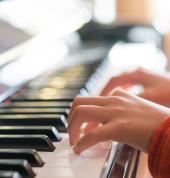 a child's hands on piano keys