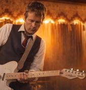 Simon Morel playing guitar at a gig