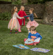 Henry studies his Everglades activity book while Georgia, Nina and Jessica play at Everglades Historic House & Gardens. Photo: David Hill, Headline Publicity