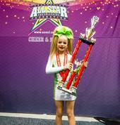 One of our Junior athletes with her and her teams National Championship trophy!