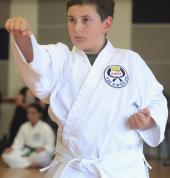 A White Belt beginner going through the 10th Kup pattern at Grading.