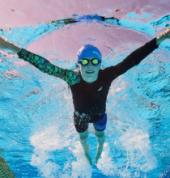 Underwater angle of young boy swimming in pool