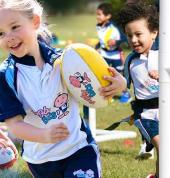 Young girl holding rugby ball