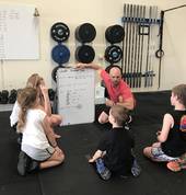 CrossFit Kids listening to what they are going to be doing.