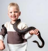 A child holding a snake