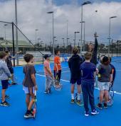 Head Coach John Trickey explaining understanding the ball toss when serving is half the battle, July Holiday Tennis Clinic 2021