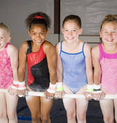 Gymnastics girls on bar in front support