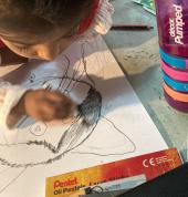 Sihara working hard on a drawing of a cat