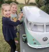 Happy kids pouring their own drinks from the mini kombi drink station!