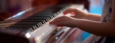 Young Child’s hand playing piano