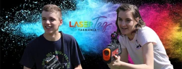 two kids playing laser tag with banner