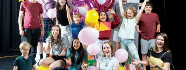 Children and young adults celebrating 50 years with balloons
