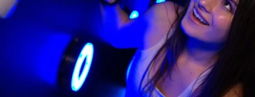 Woman enjoying an interactive light game at Power Play Sydney indoor activity venue