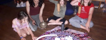 Children with hands on sound instruments at Ashtanga Yoga studio