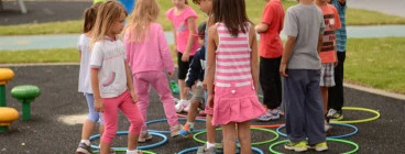 Kids use their initiative to step into a hoop that nobody is in.  Its also a game of sharing and caring for your friends.