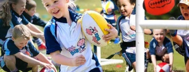 Young girl holding rugby ball