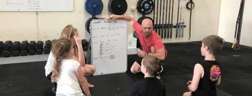 CrossFit Kids listening to what they are going to be doing.