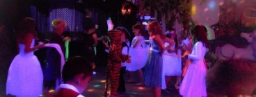 Kids dressed up and having fun at one of our glow in the dark Birthday disco parties.
