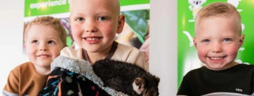 A child holding a possum