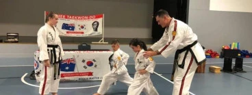 Young students getting one on one instruction from Master Instructor for Australia Jerry