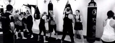 a ladies fitness class punching the bags!